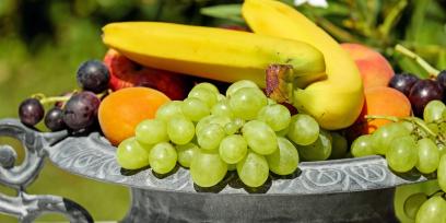 Diferentes frutas (bananas, uvas, ciruelas y duraznos). Imagen libre de derechos de autor. 