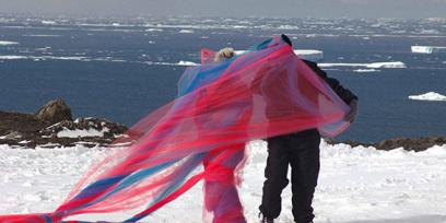 Dos personas caminan con tules de distintos colores por la Antártida