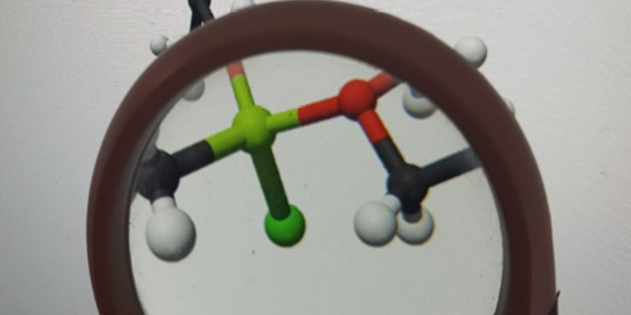 Modelo de moléculas bajo una lupa.