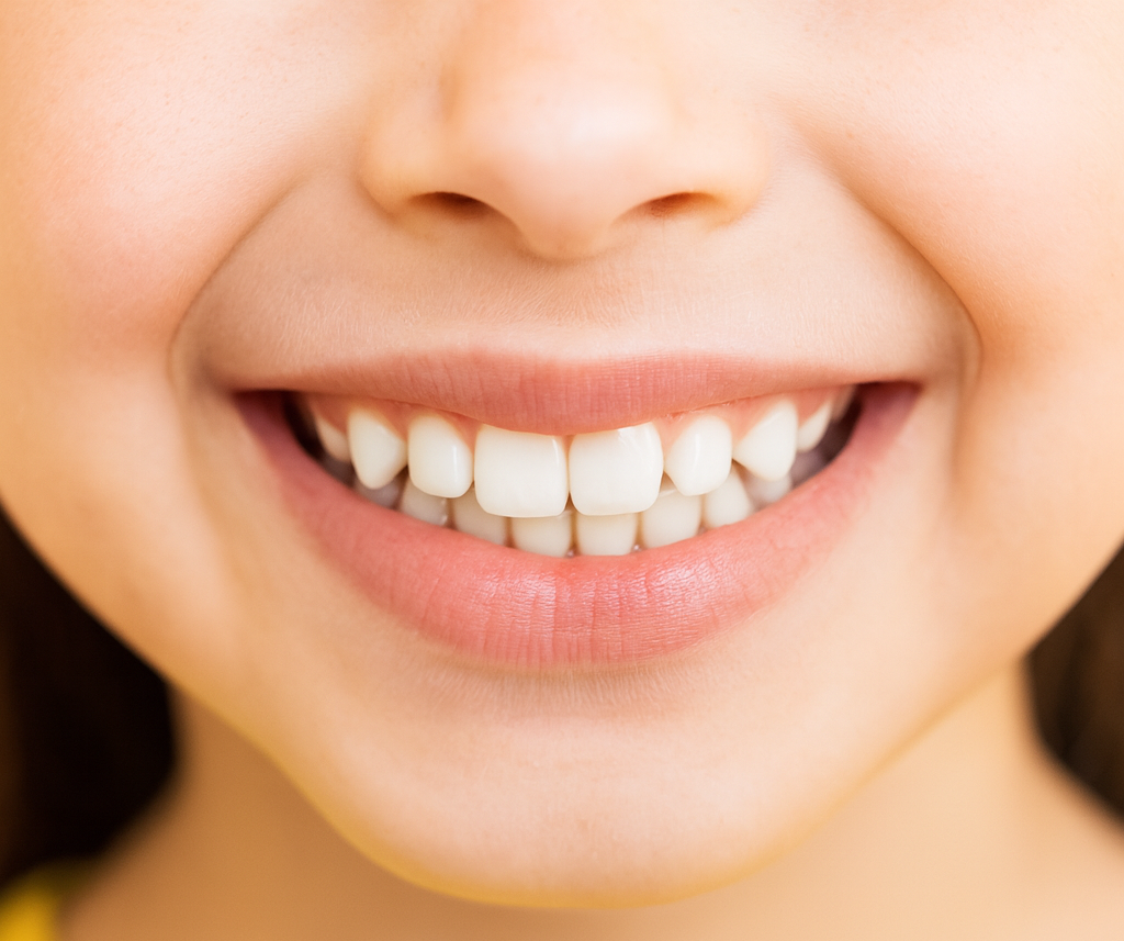 Niña sonriendo con dientes bien limpios