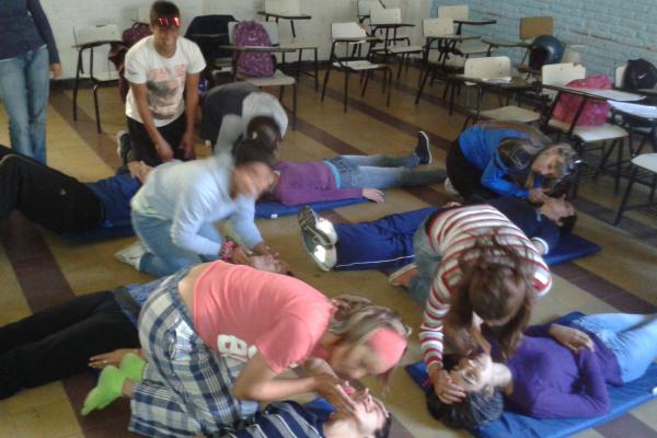 Jóvenes realizando práctica de reanimación cardiorespiratoria.
