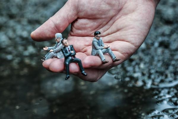 figura humana en miniatura sobre mano tamaño real