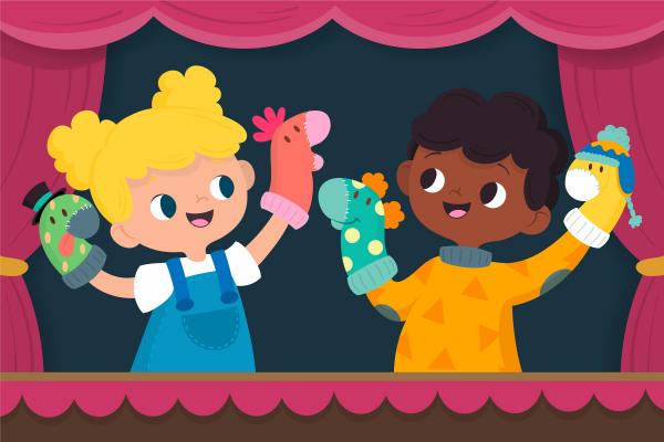 niños representandouna obra de títeres