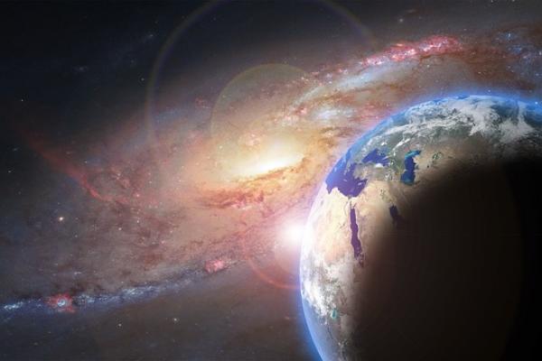 Planeta Tierra en el espacio. Una parte se ve iluminada, la otra no. 